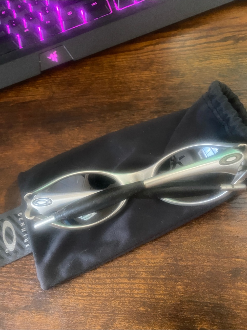 Oakley Silver Frame Sunglasses with Black Lenses